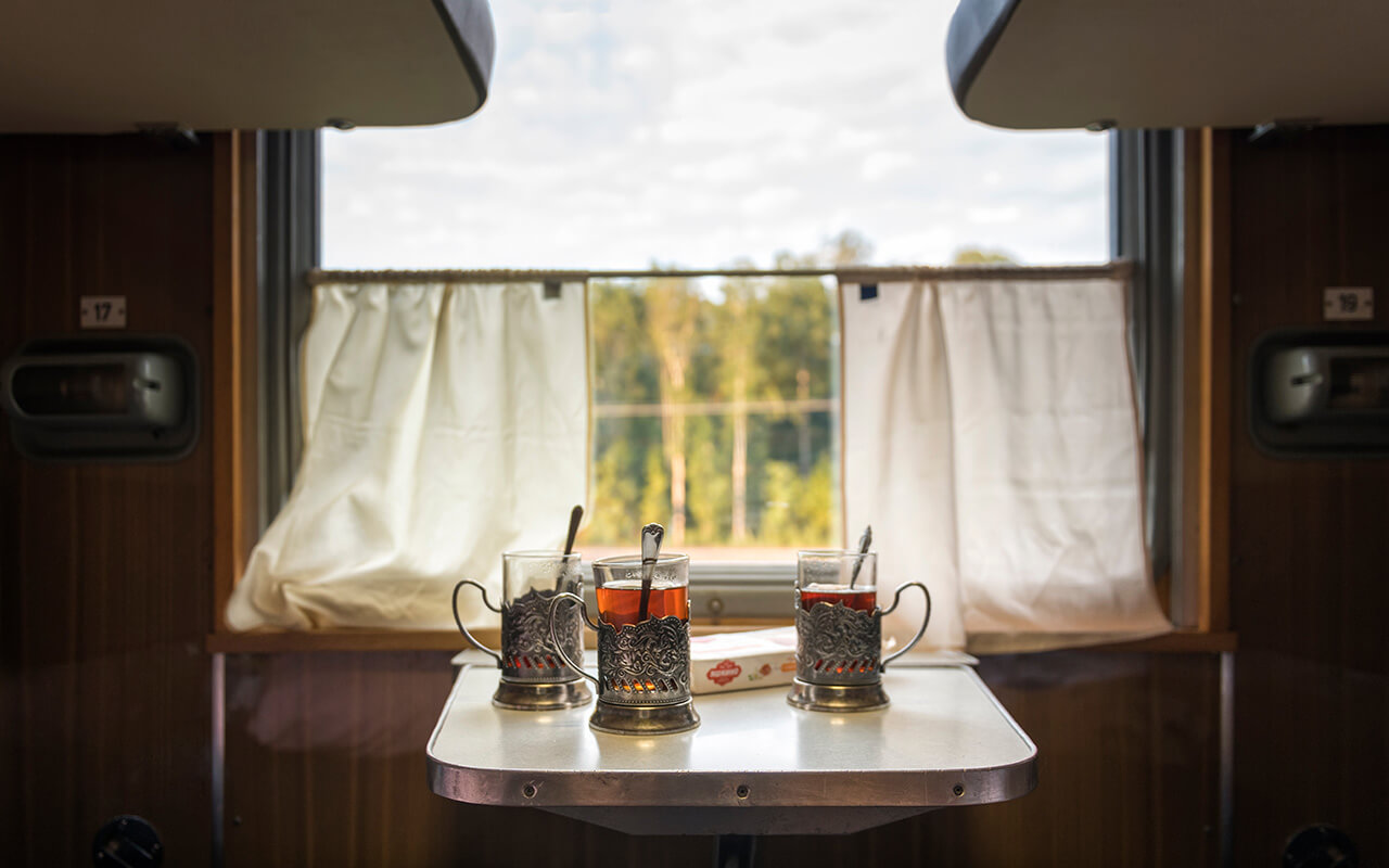 glasses, cups of tea on the table in the train