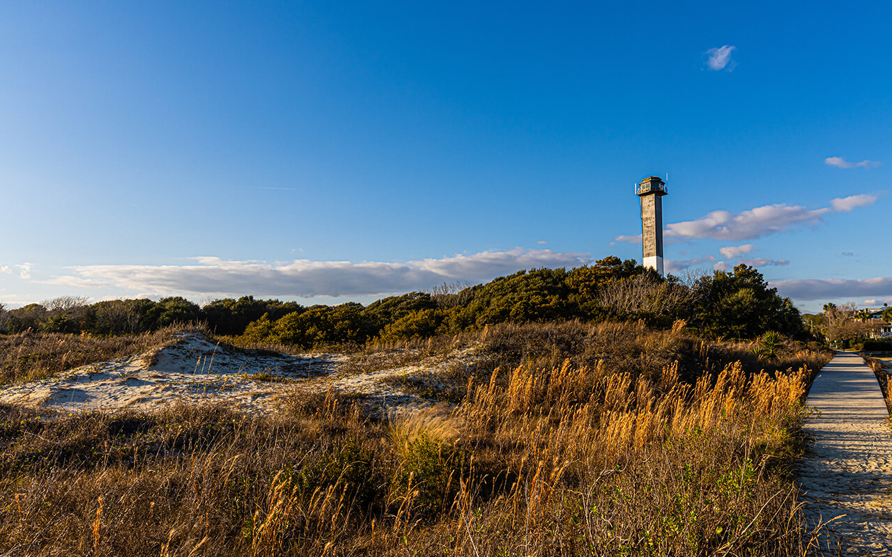 The Sand Dunes of Station 18 Beach and Sullivan's Island Lighthouse, Sullivan's Island, South Carolina, USA