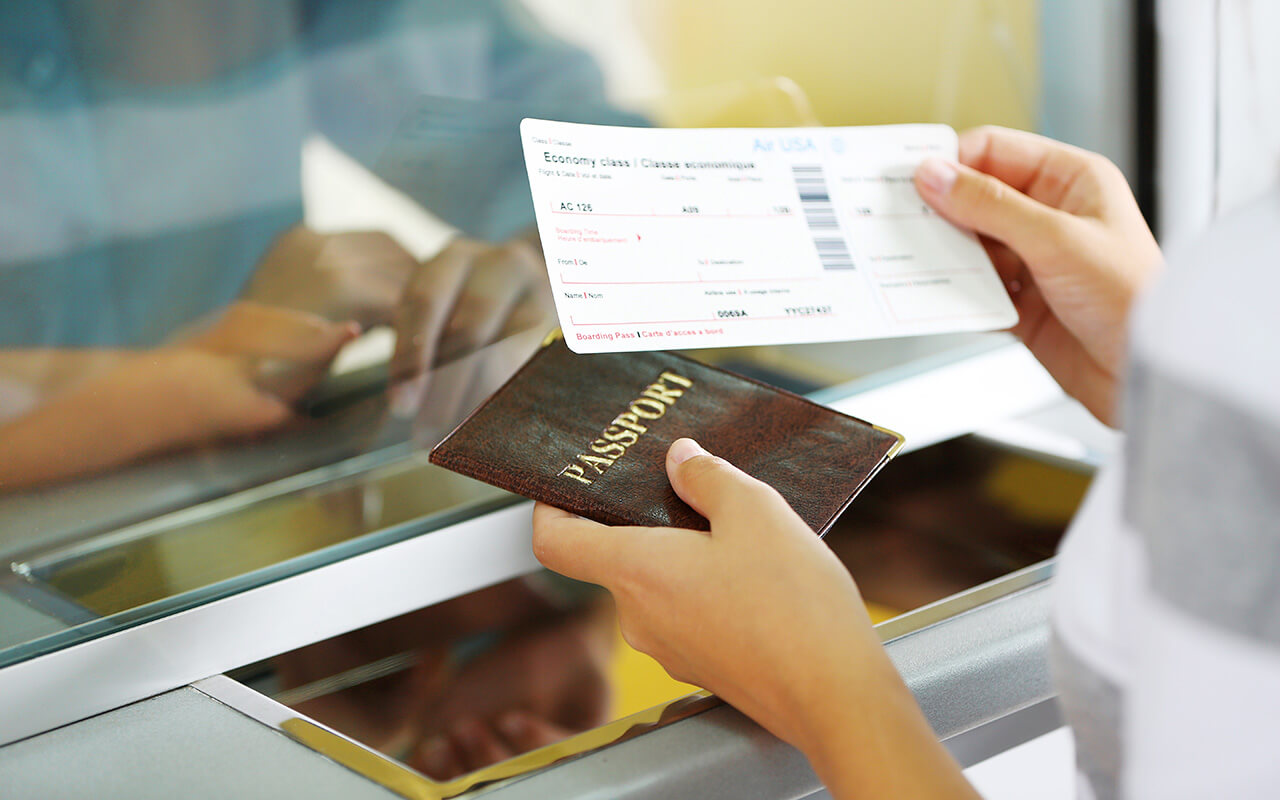 Woman holding passport and boarding pass