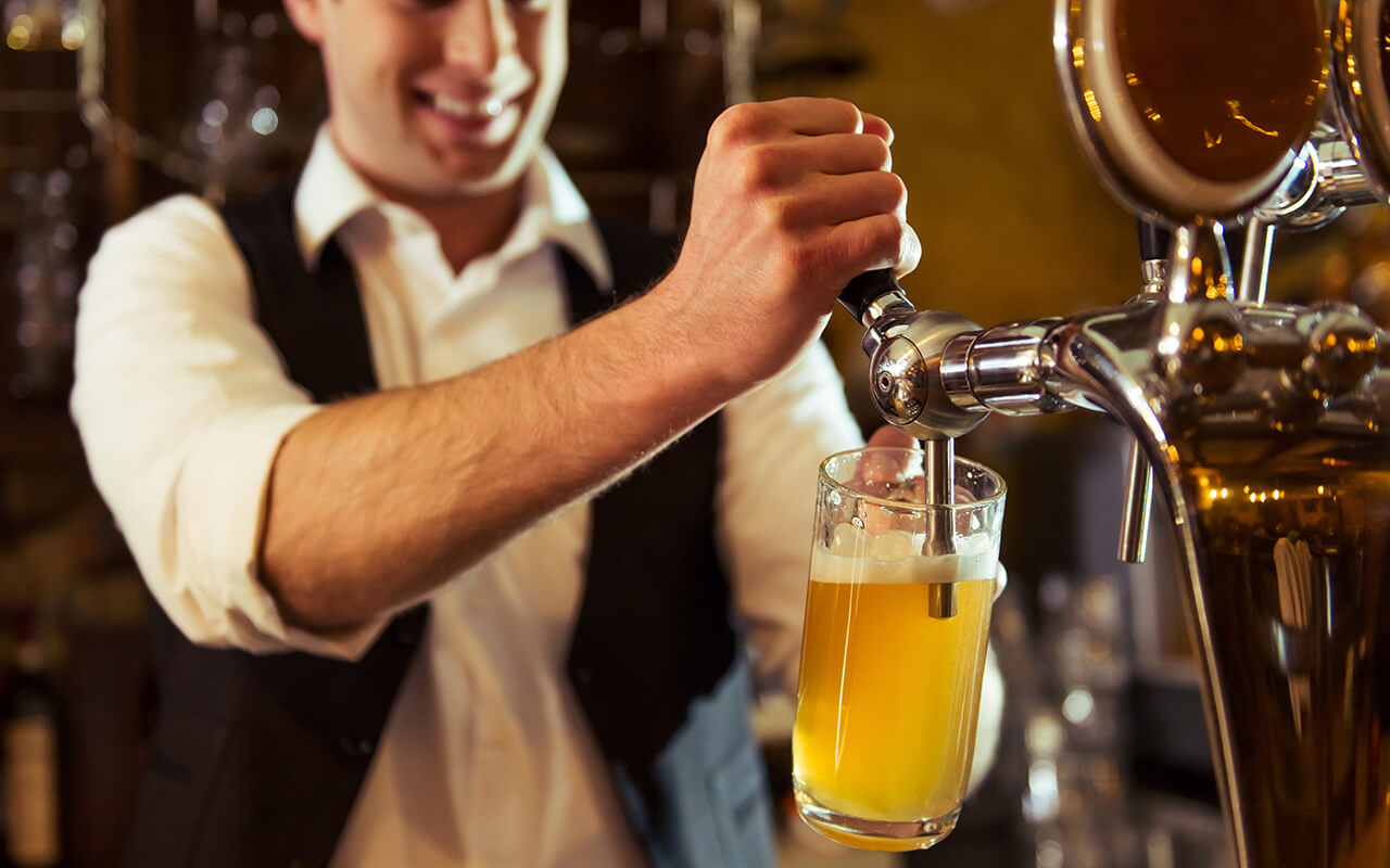 Bartender working, pouring a beer