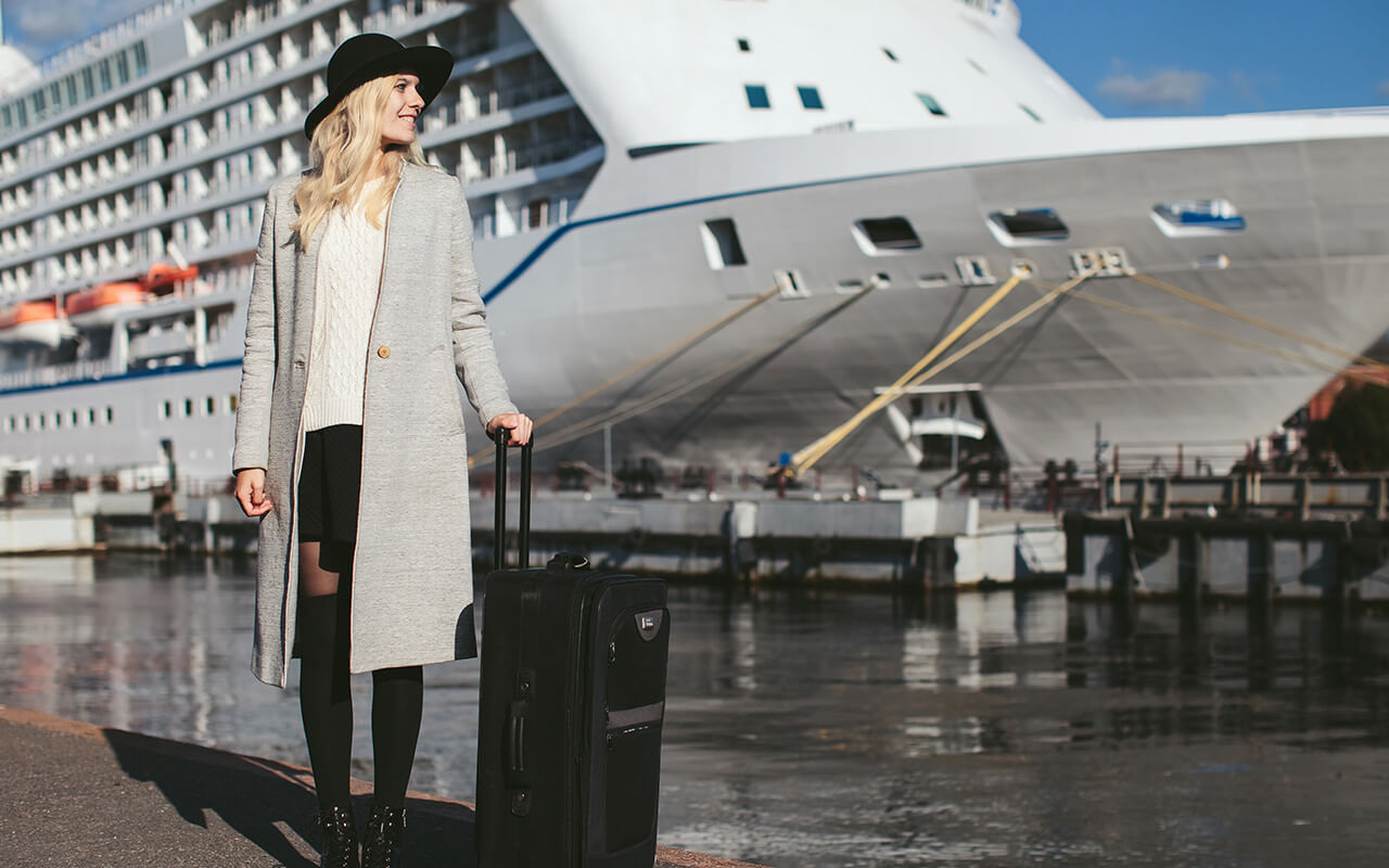 Woman with suitcase about to board a cruise