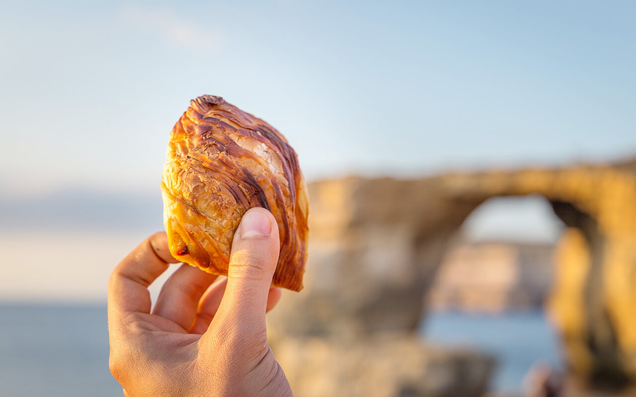 Pastizz, Traditional Maltese Food on Azure Window Background, Gozo, Malta