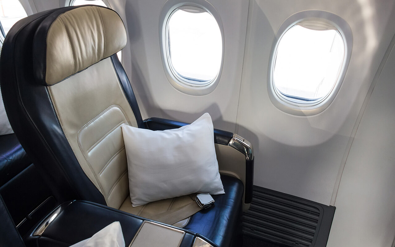 Airplane seat with a pillow on it