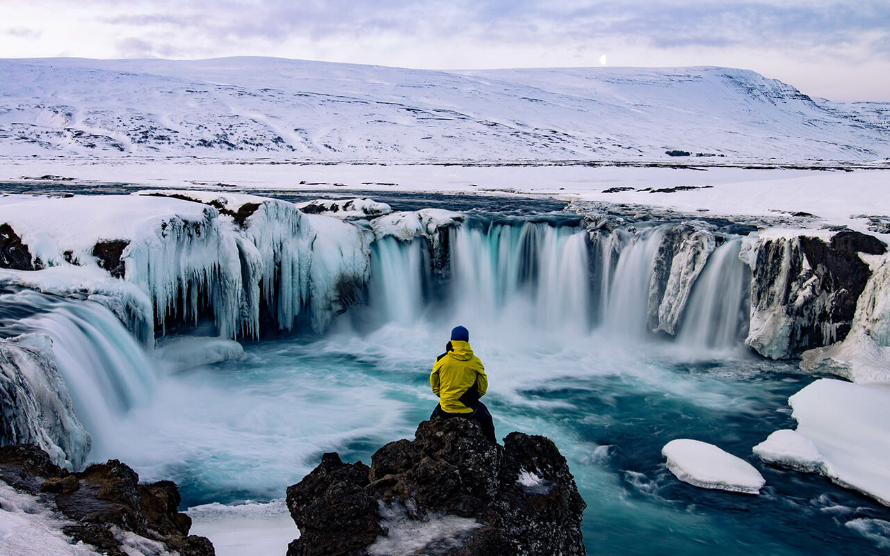 Adventurous man at Godafoss, Iceland in winter