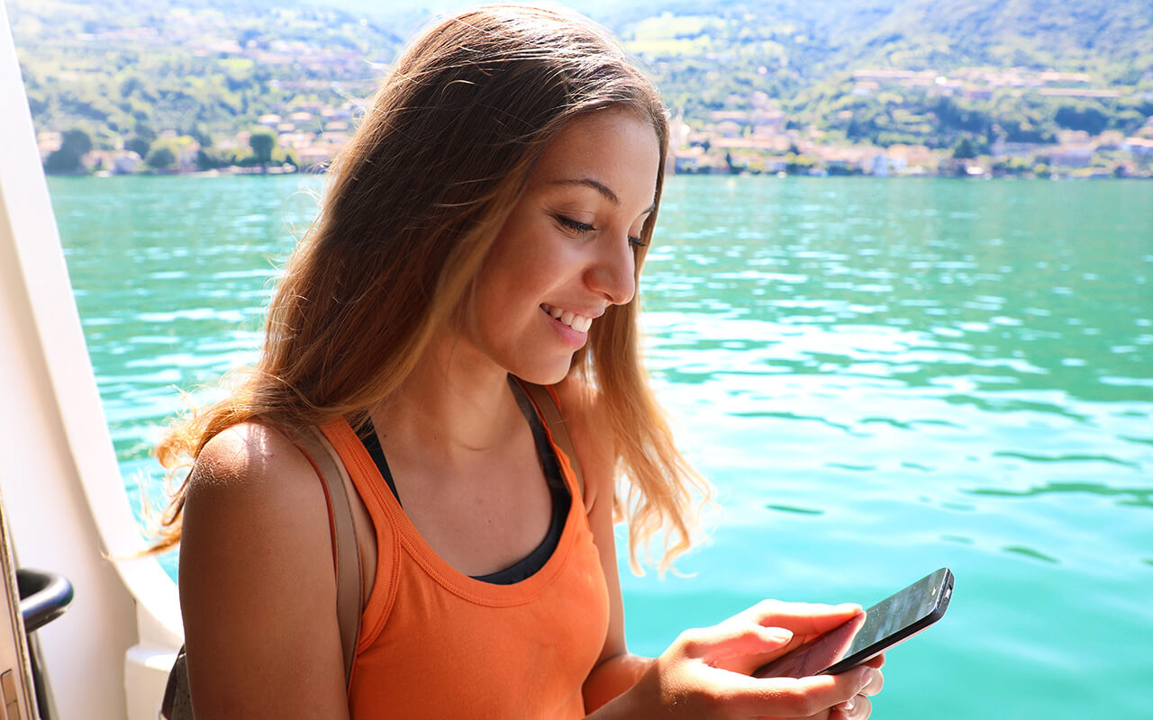 Woman using a phone on a ship