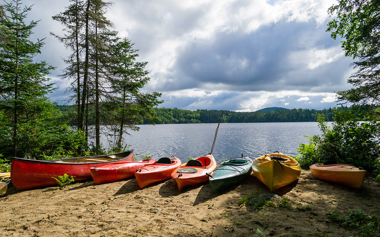 Kayaks and a canoe by the Indian lake in upstate New York