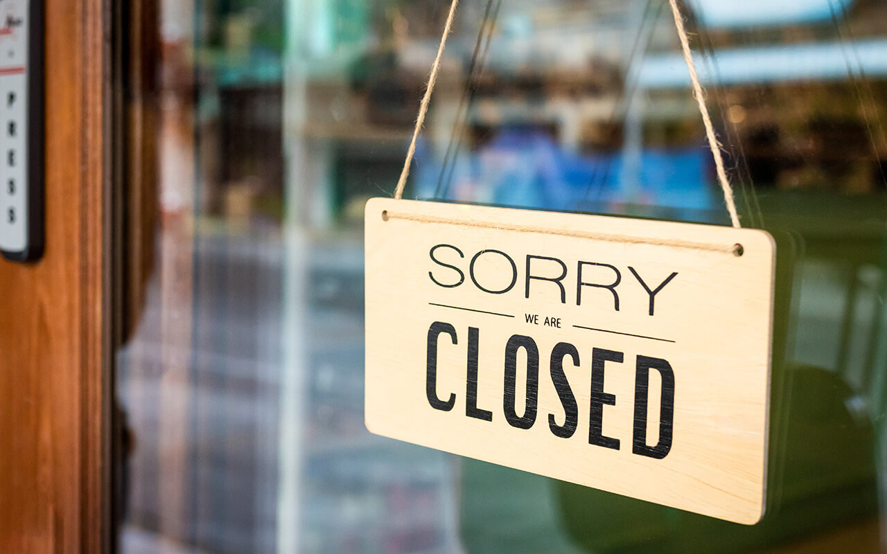 Sign on a door that reads "Sorry we are closed"