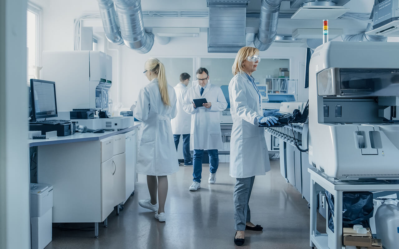 Team of Research Scientists Working On Computer, with Medical Equipment