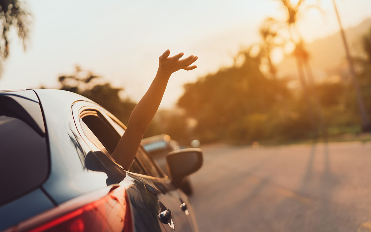 Hatchback Car travel driving road trip of woman summer vacation in blue car at sunset