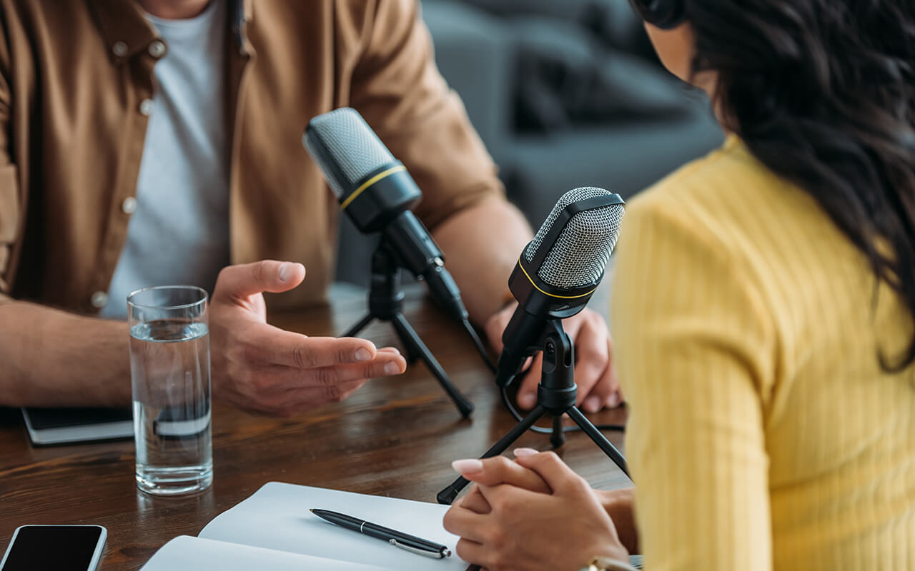 Two people recording a podcast