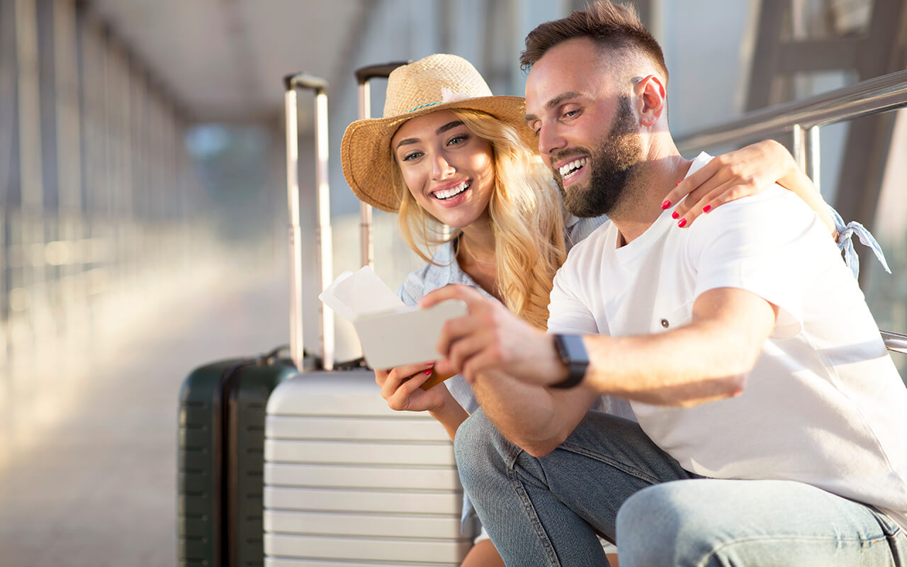 Friends taking a photo together at the airport