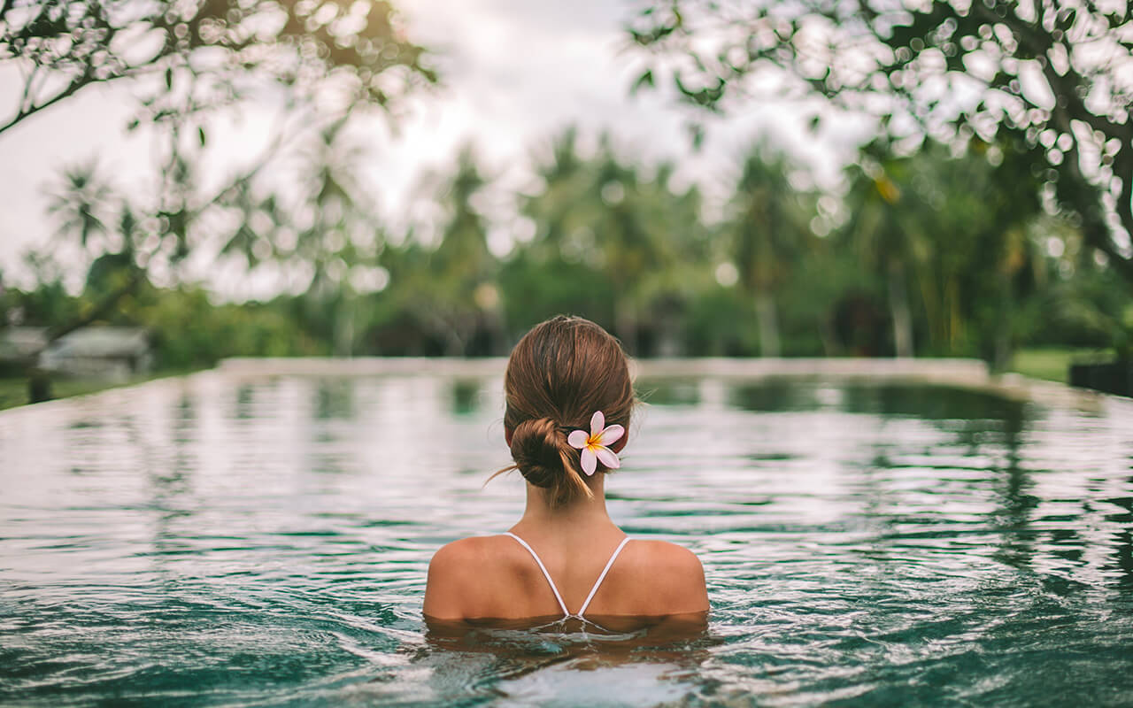 Infinity pool with a view on palm trees, Ubud, Bali