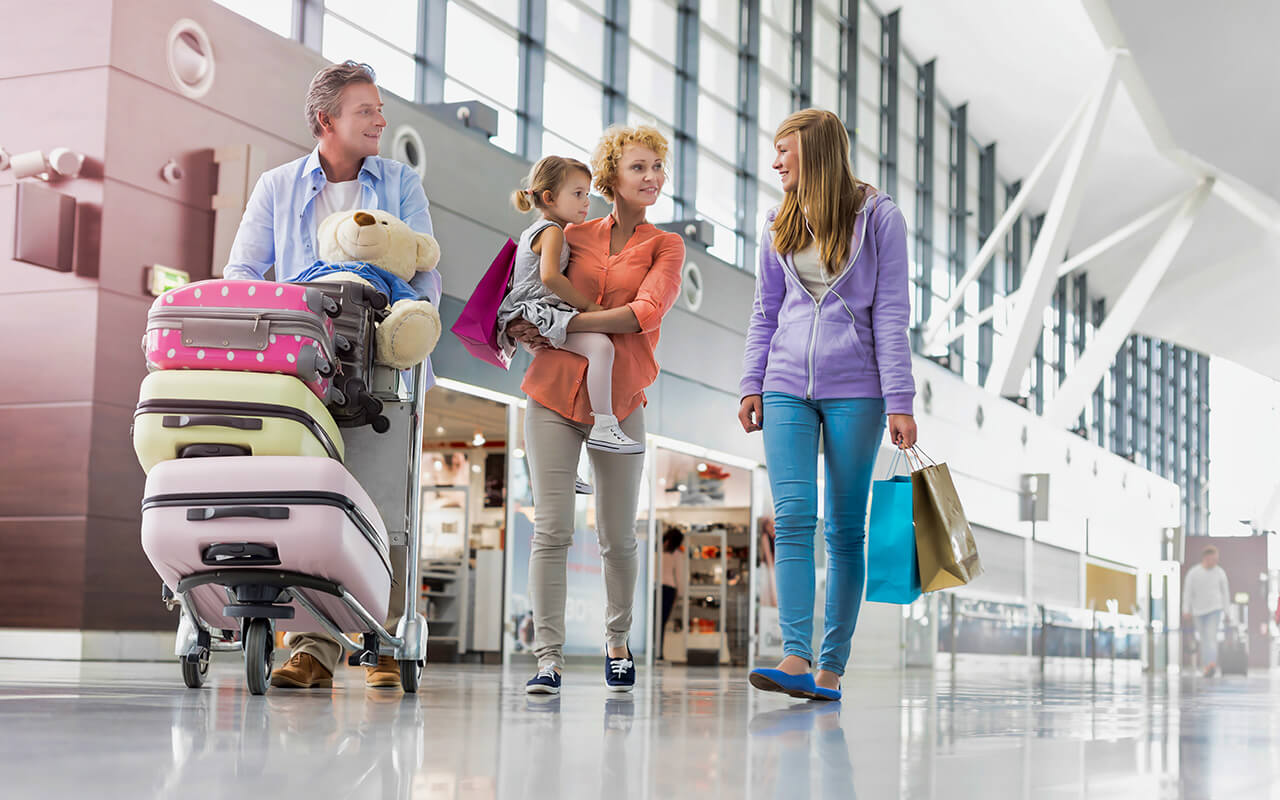 Family walking through the airport