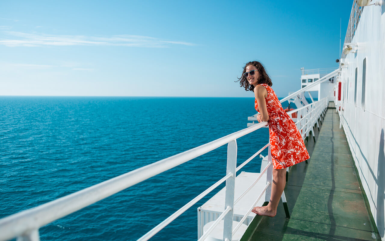 Woman looking off a cruise boat