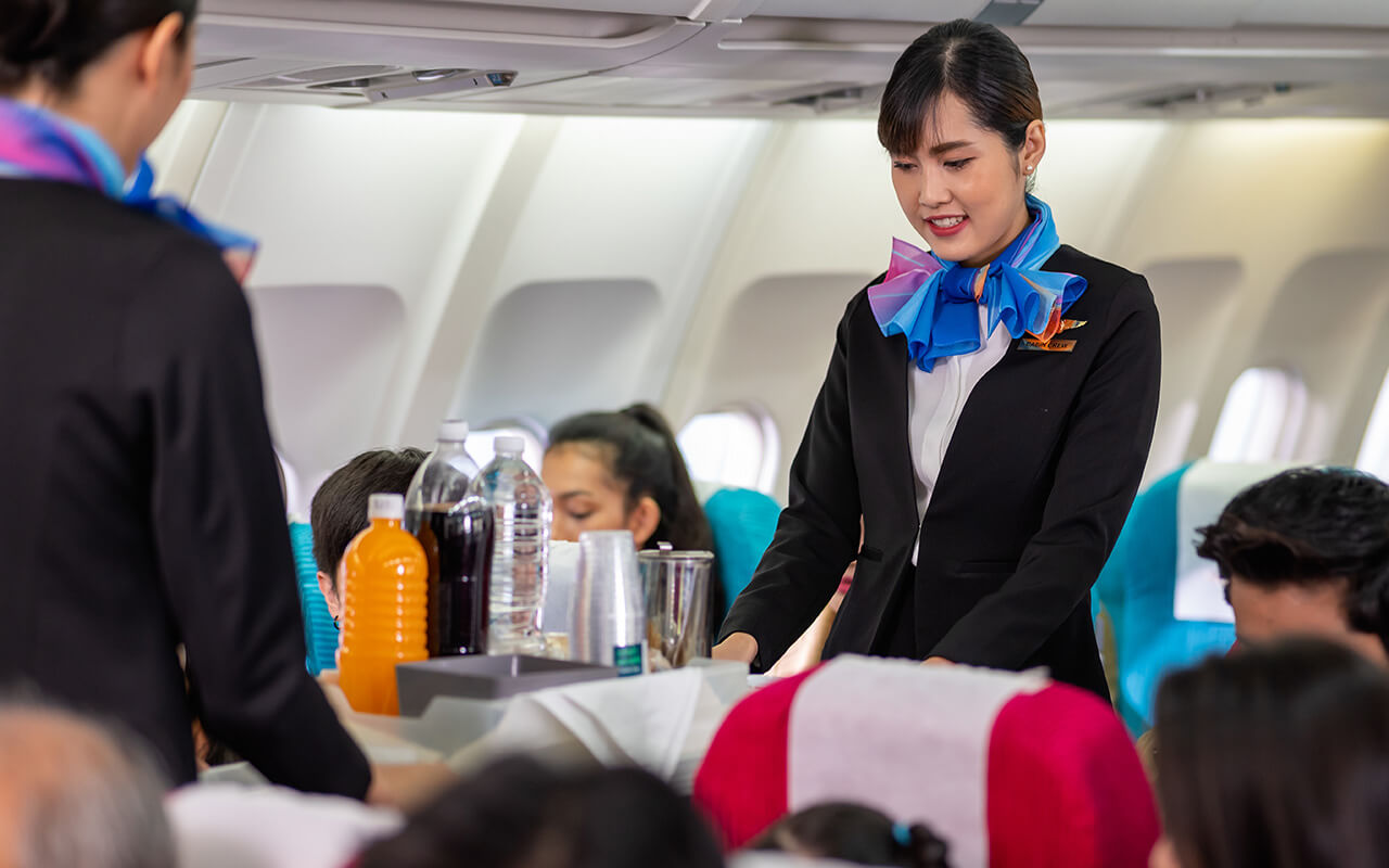 Flight attendants serving drinks