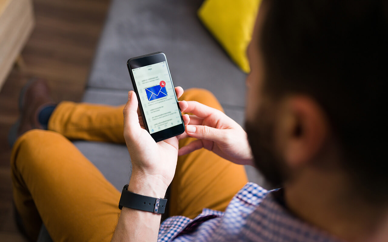 Man receiving a notification from his email