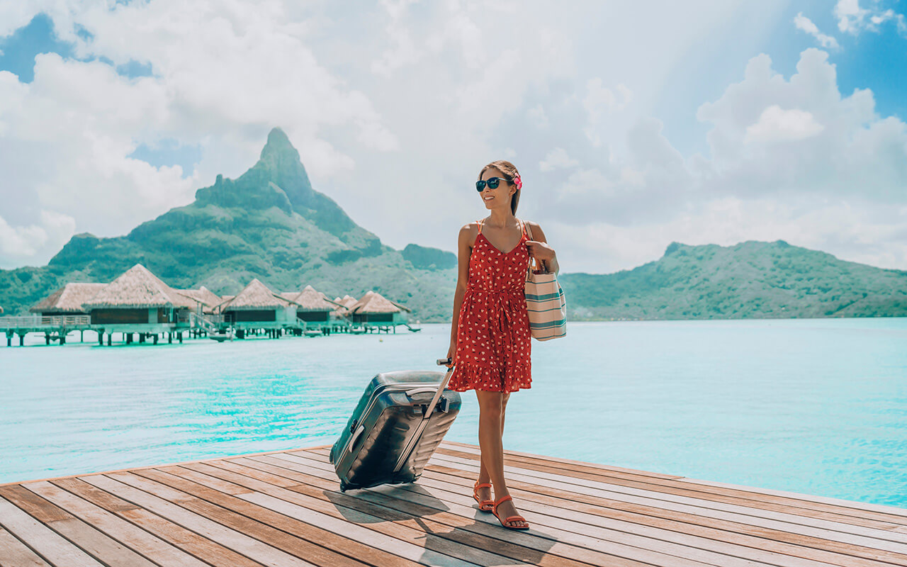 Woman with a suitcase on a pier