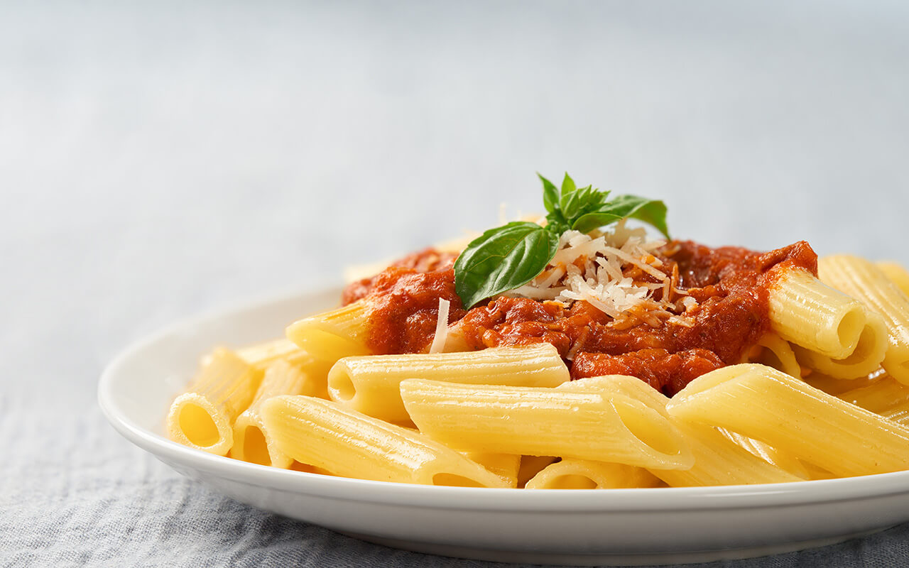 A plate of pasta with tonato sauce