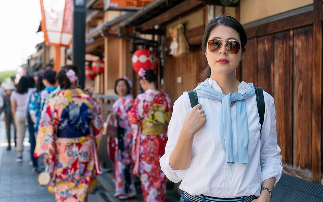 stylish asian chinese woman looking around Gion Hanamikoji Street in Kyoto japan