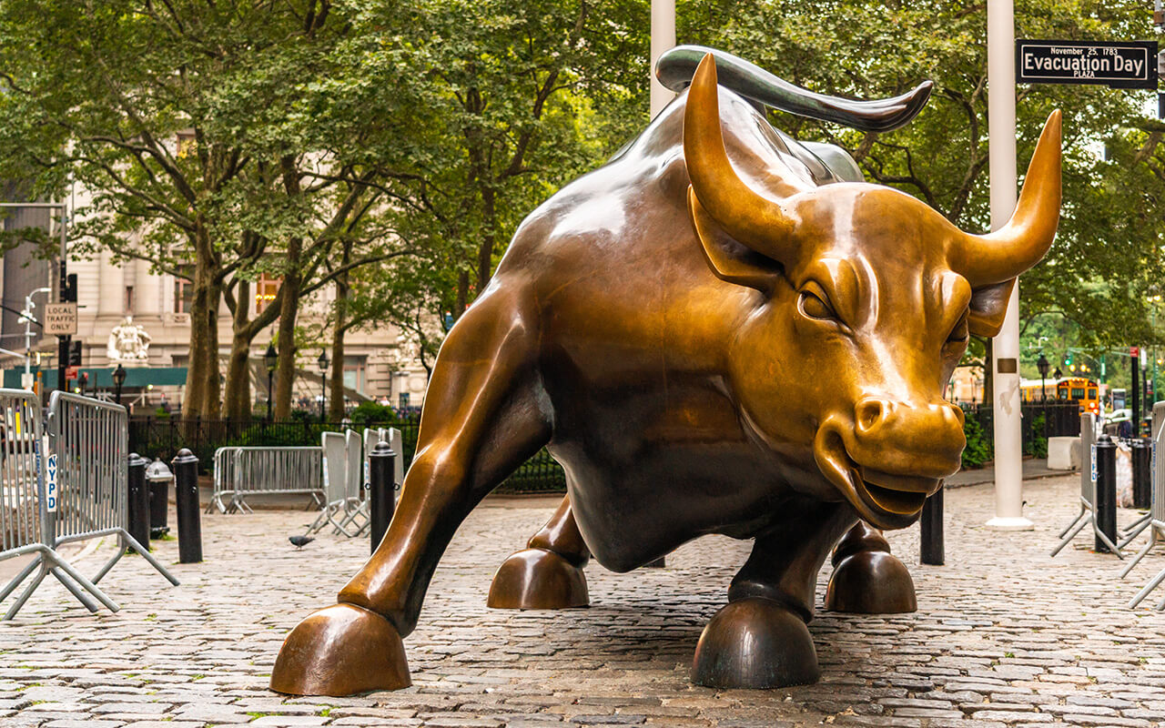 Wall Street stock exchange charging metal bull in NYC Manhattan