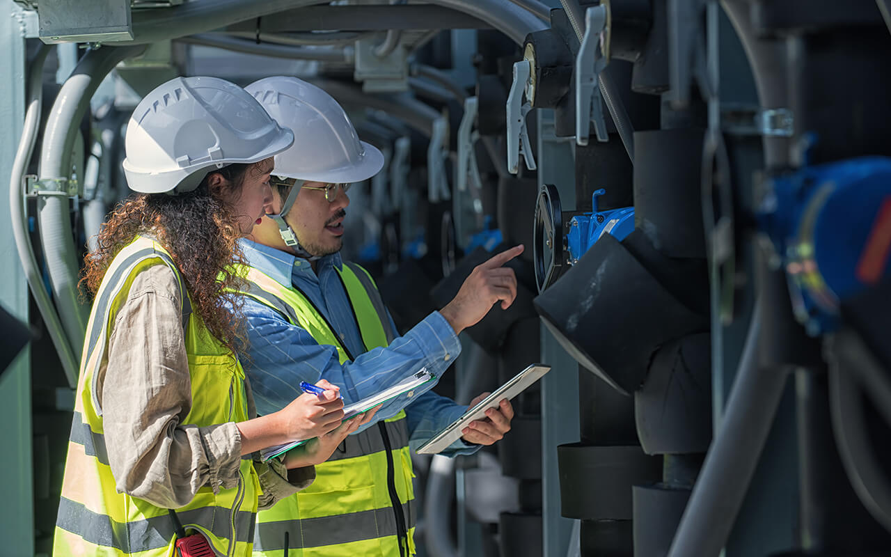 worker checking job in plant room.