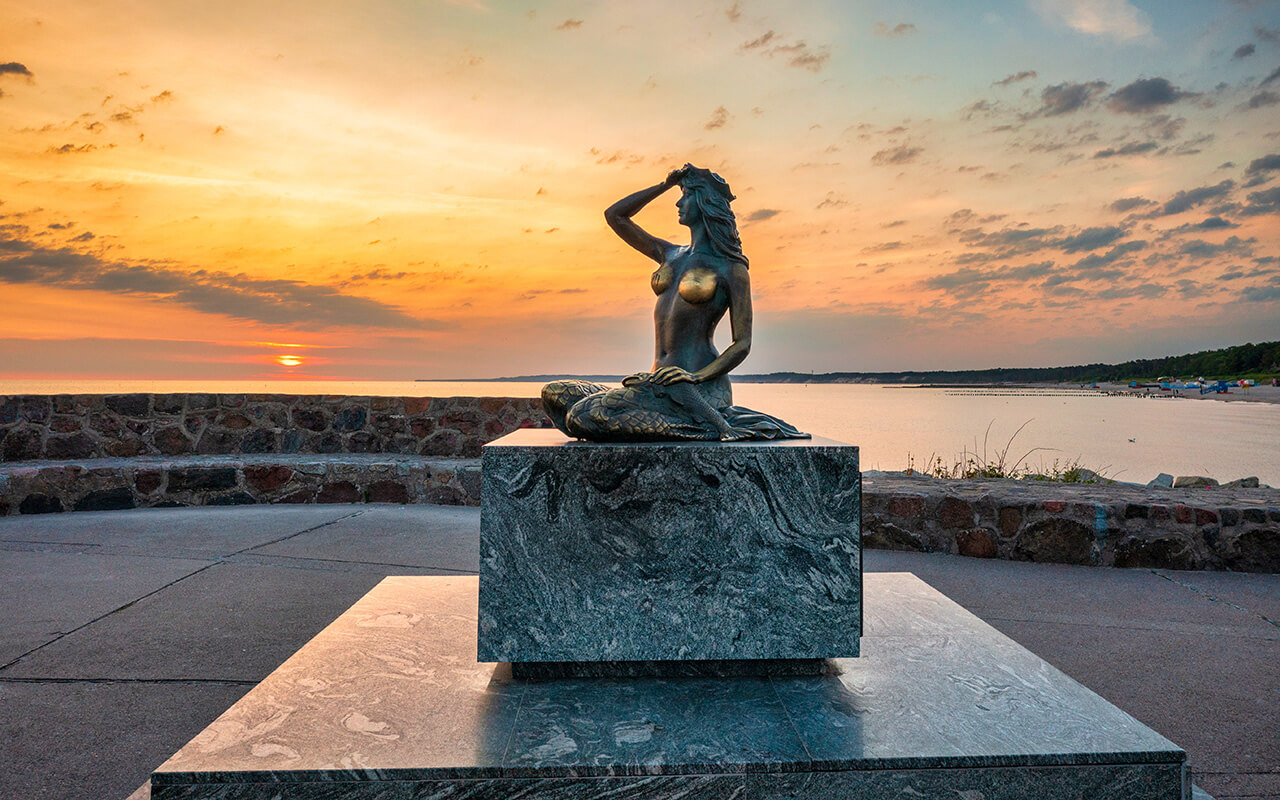 Mermaid statue by the Baltic Seain Ustka at sunrise