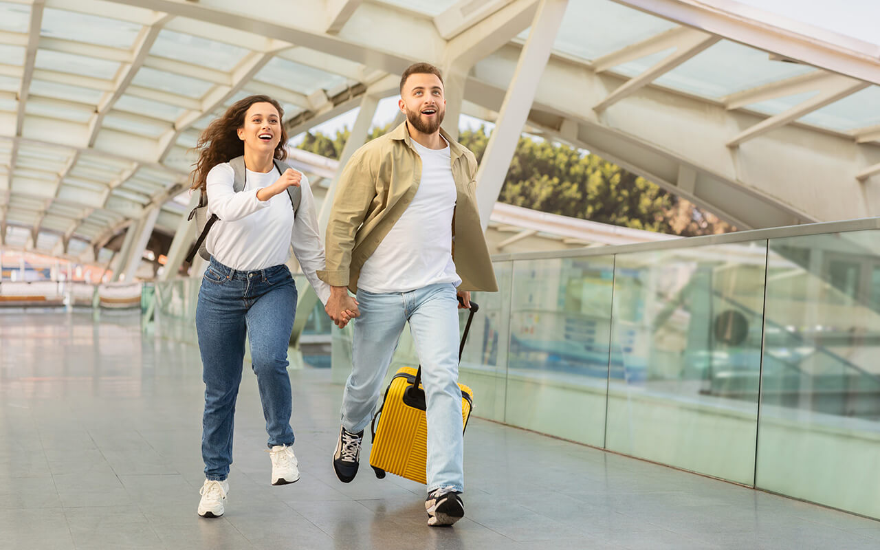 Couple running through the airport