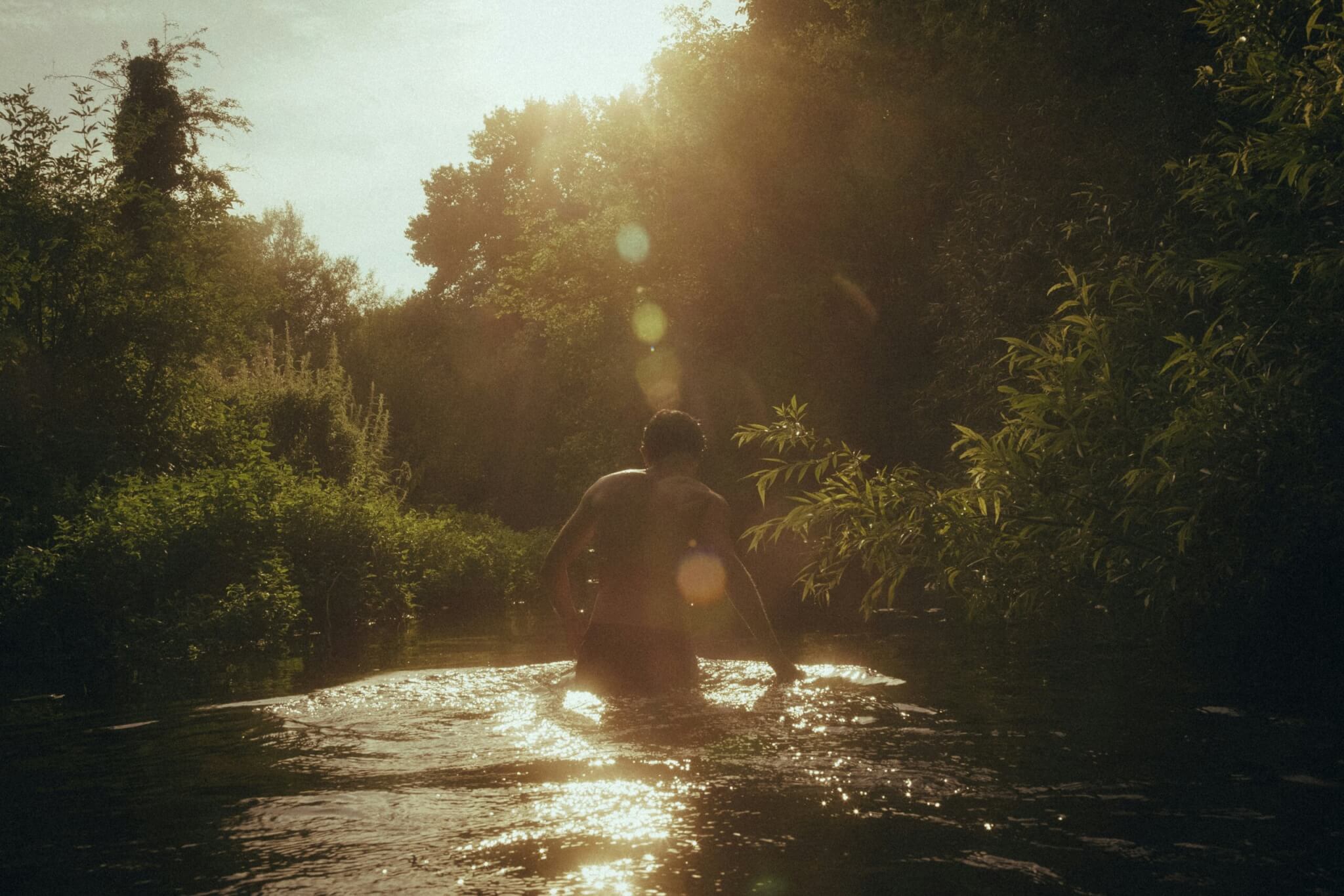 man swimming in a river