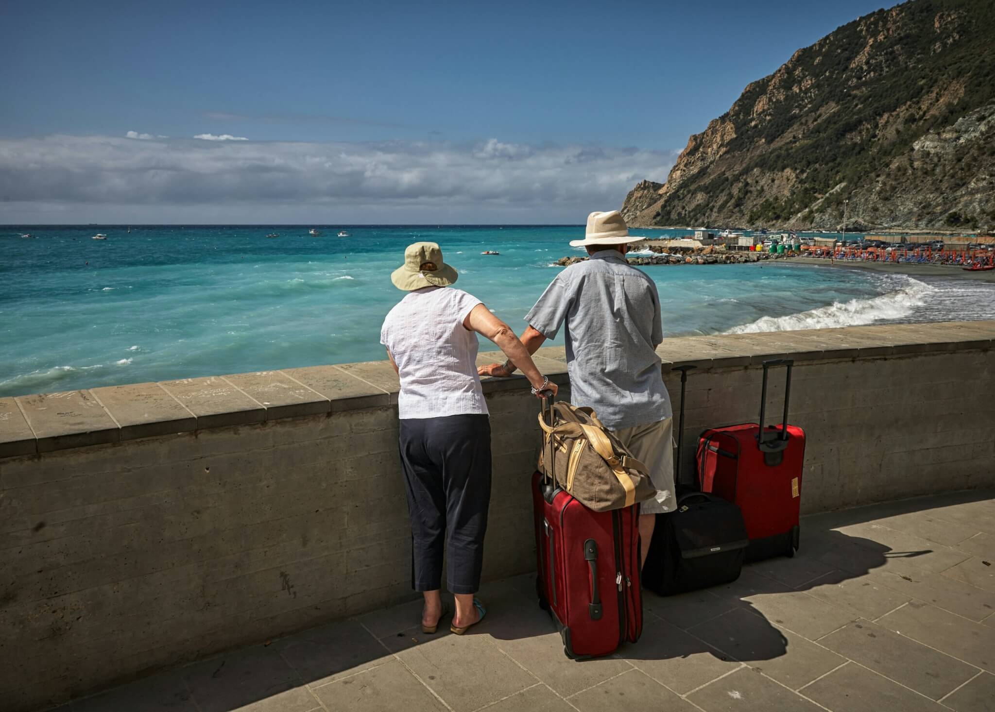 two people with suitcases