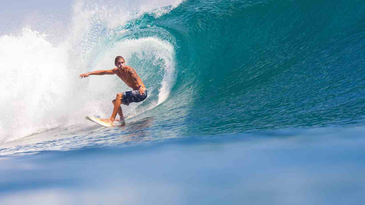 a person riding a wave on a surfboard