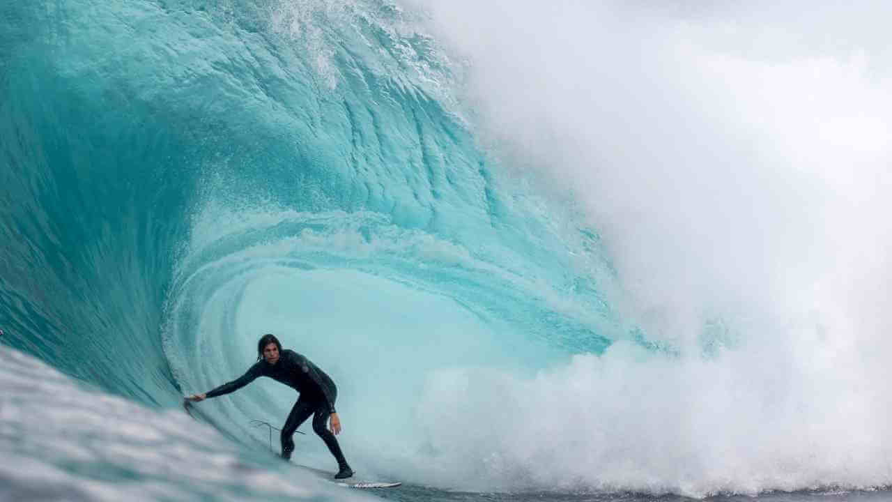 a surfer riding a large wave in the ocean