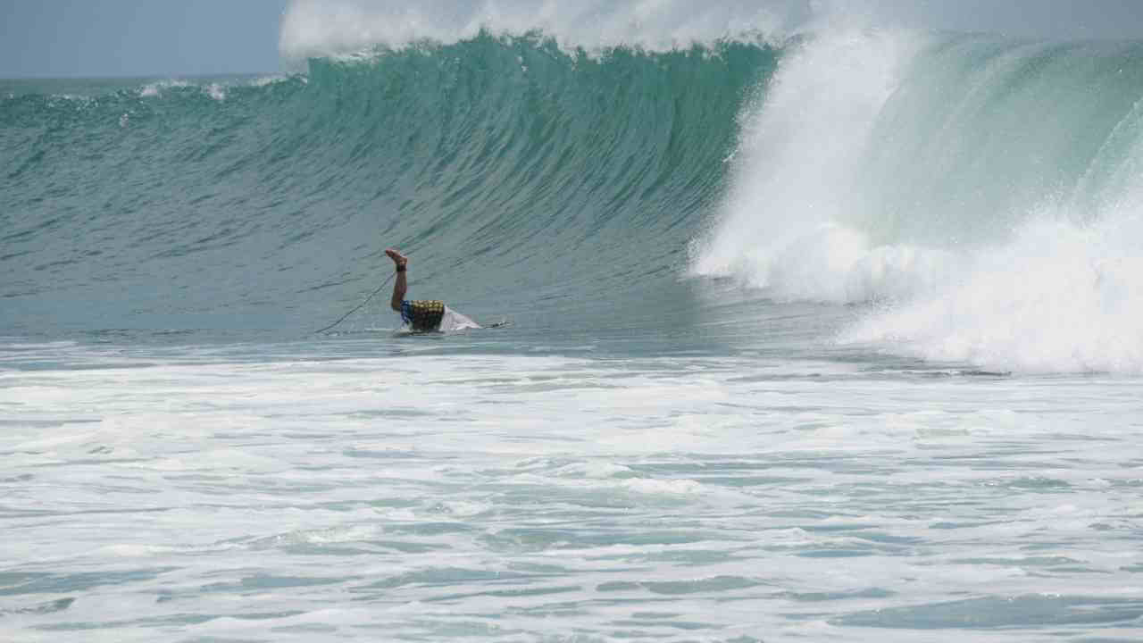 a surfer riding a large wave in the ocean