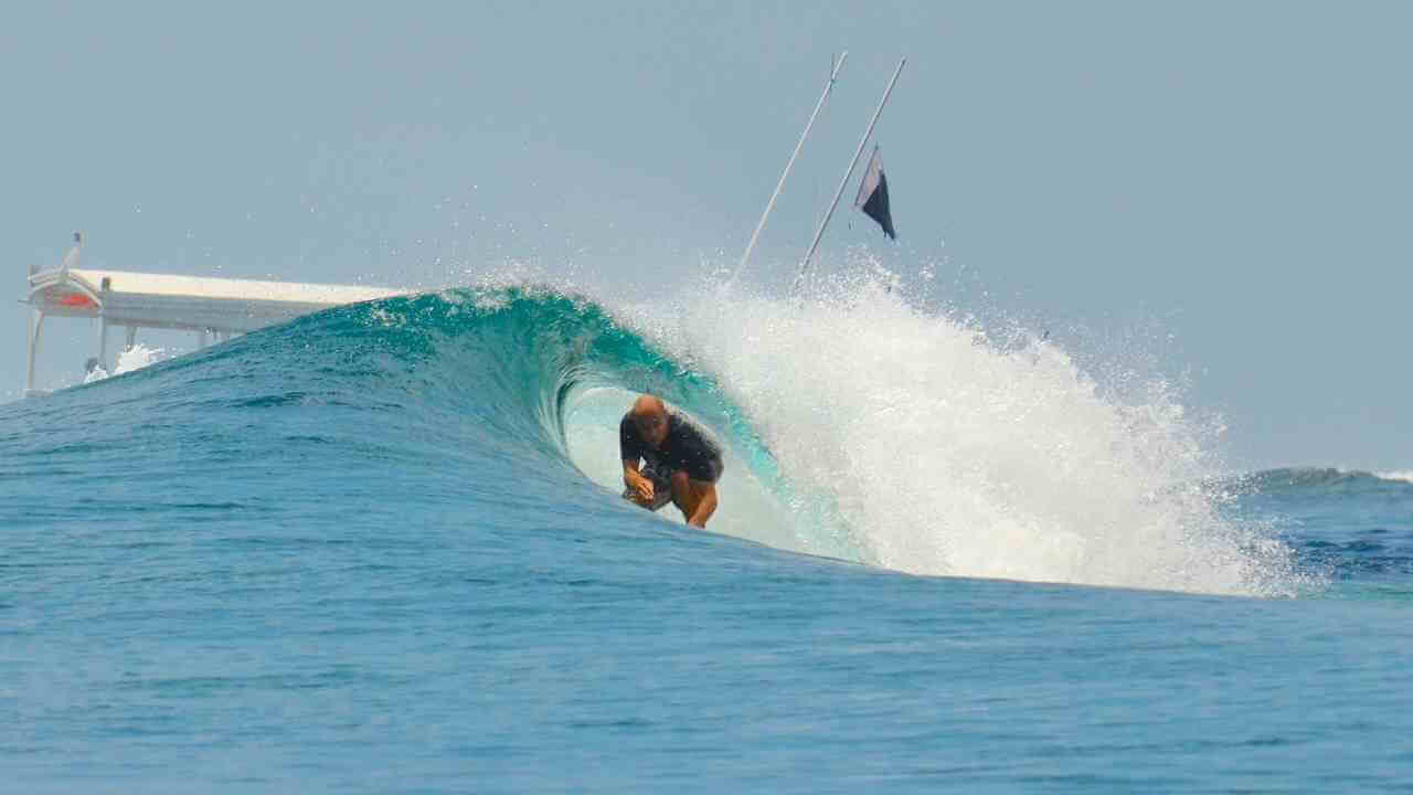 a person riding a wave on a surfboard