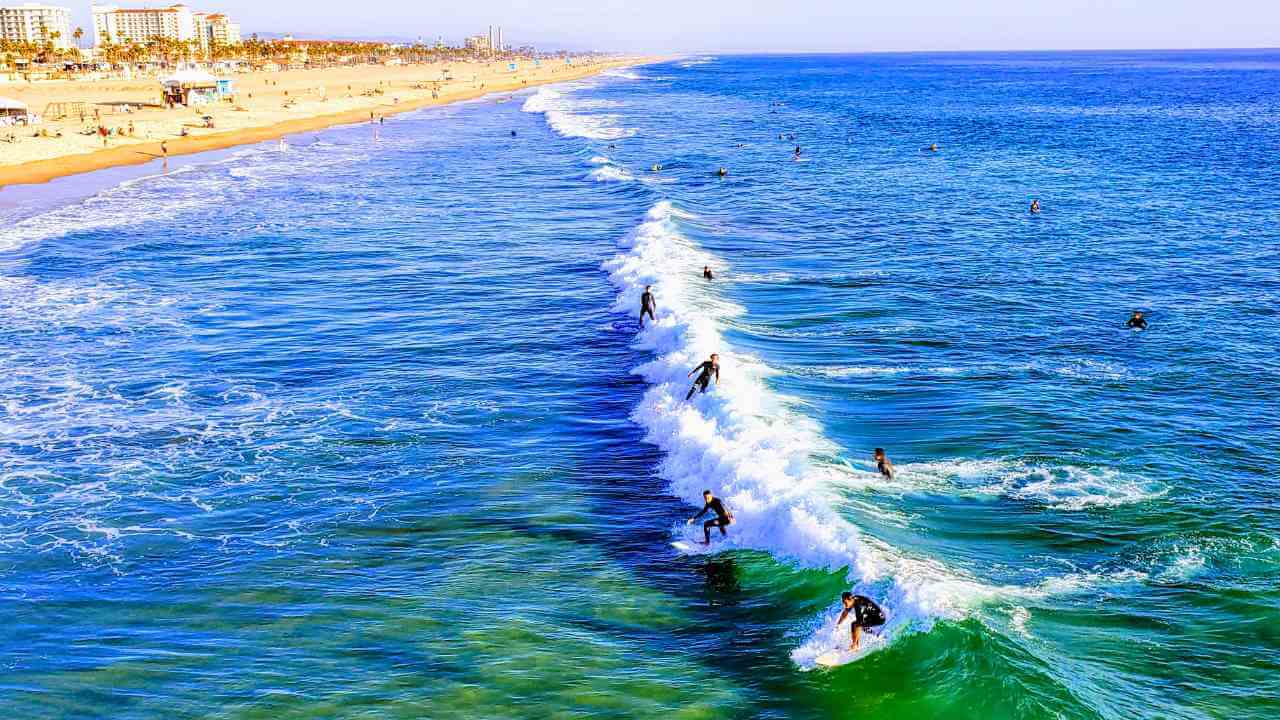 surfers ride the waves at the beach in venice, california