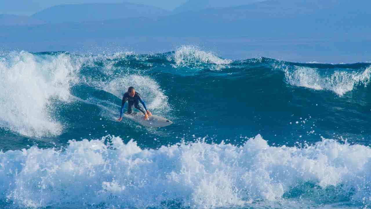 a person riding a wave on a surfboard