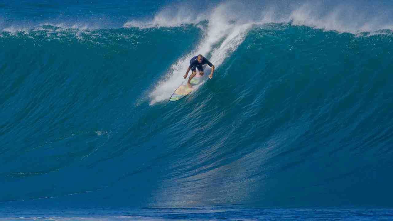 a person riding a wave on a surfboard