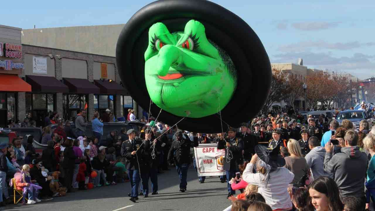 a float in a halloween parade with people in the street