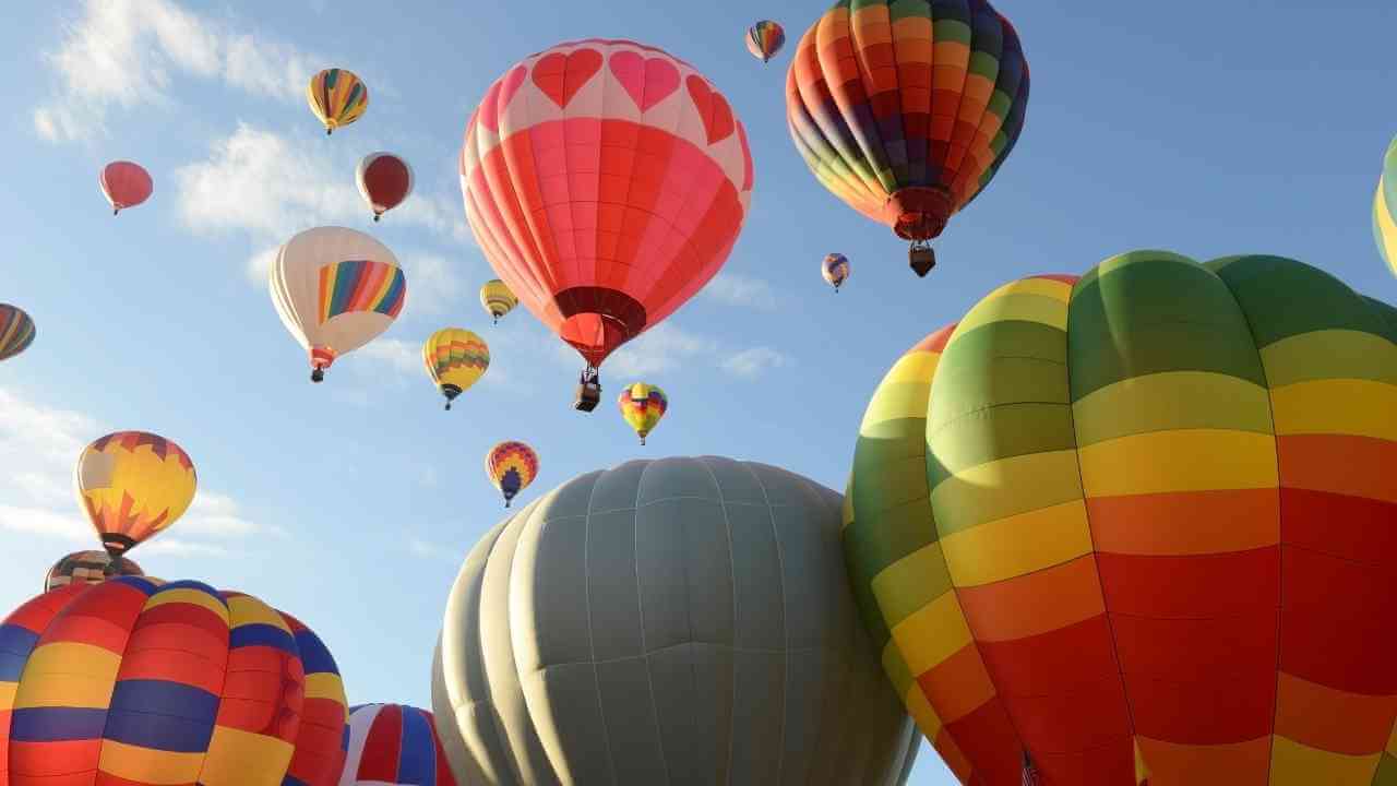 many colorful hot air balloons are flying in the sky