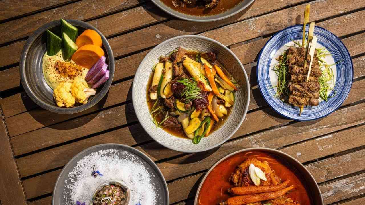 various plates of food on a wooden table