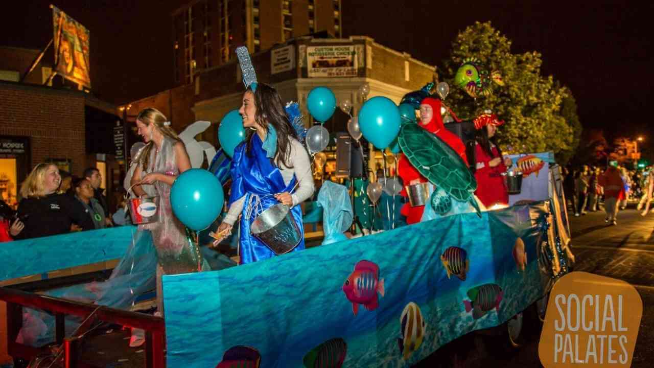 a float in a parade with people dressed as mermaids