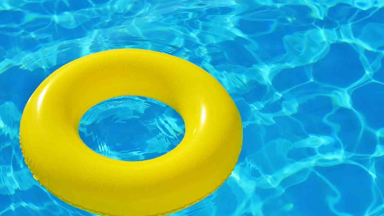 an inflatable yellow ring floating in a pool