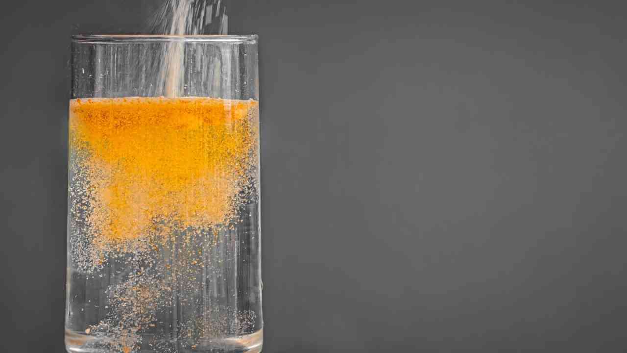 orange juice being poured into a glass