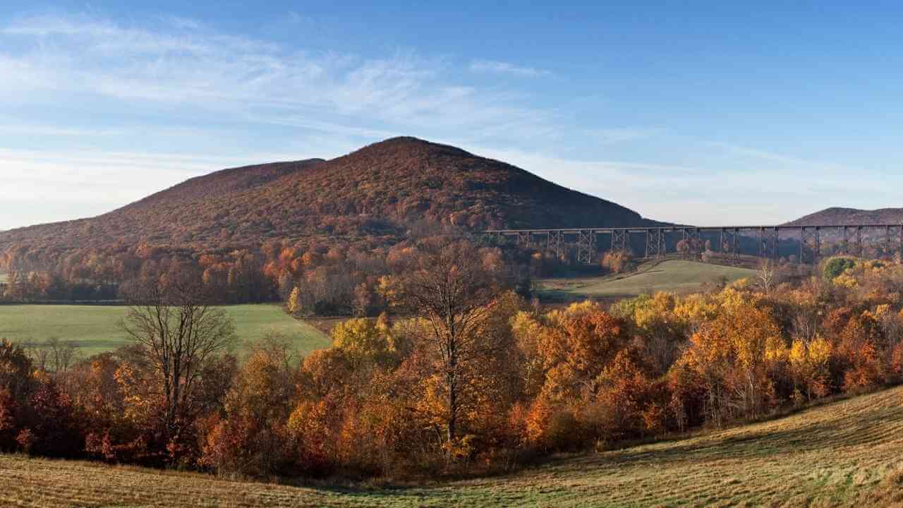 the view from the top of a hill in the fall