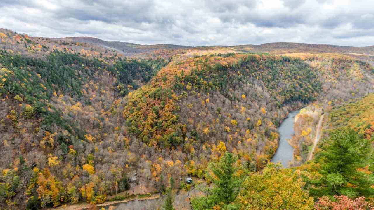 the view from the top of a mountain overlooking a river