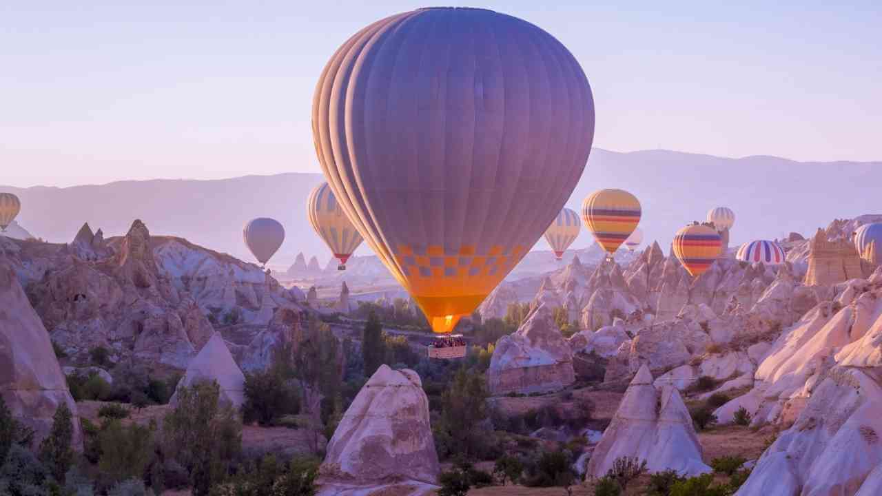 many hot air balloons are flying in the sky in cappadocia