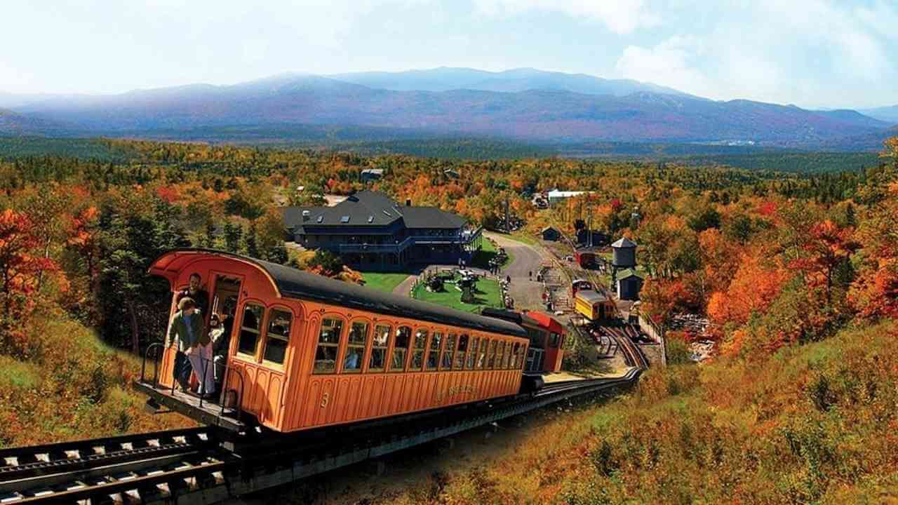 an image of a train going down the tracks in the fall