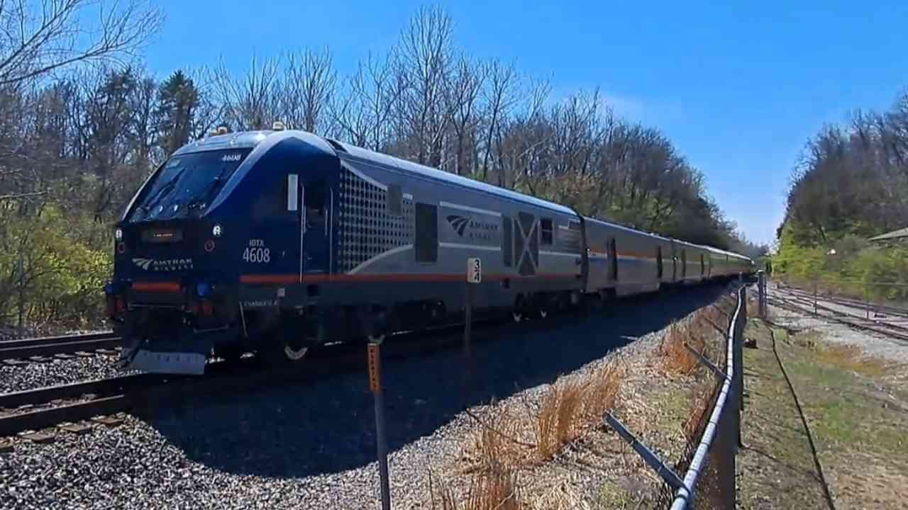 an amtrak train is traveling down the tracks