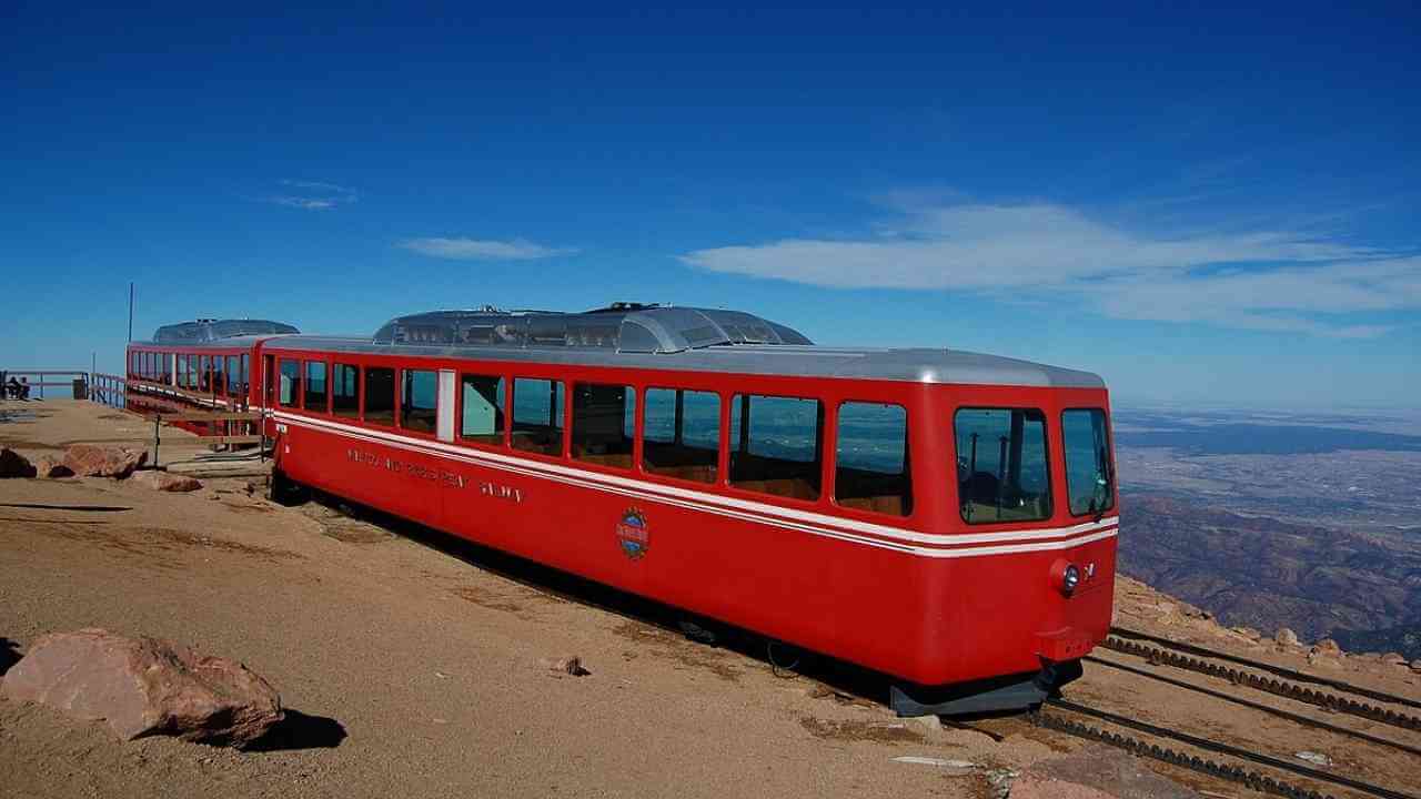 a red train on the side of a mountain