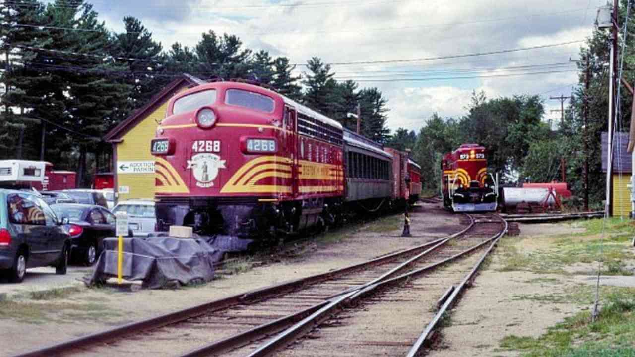 two trains are parked next to each other on the tracks