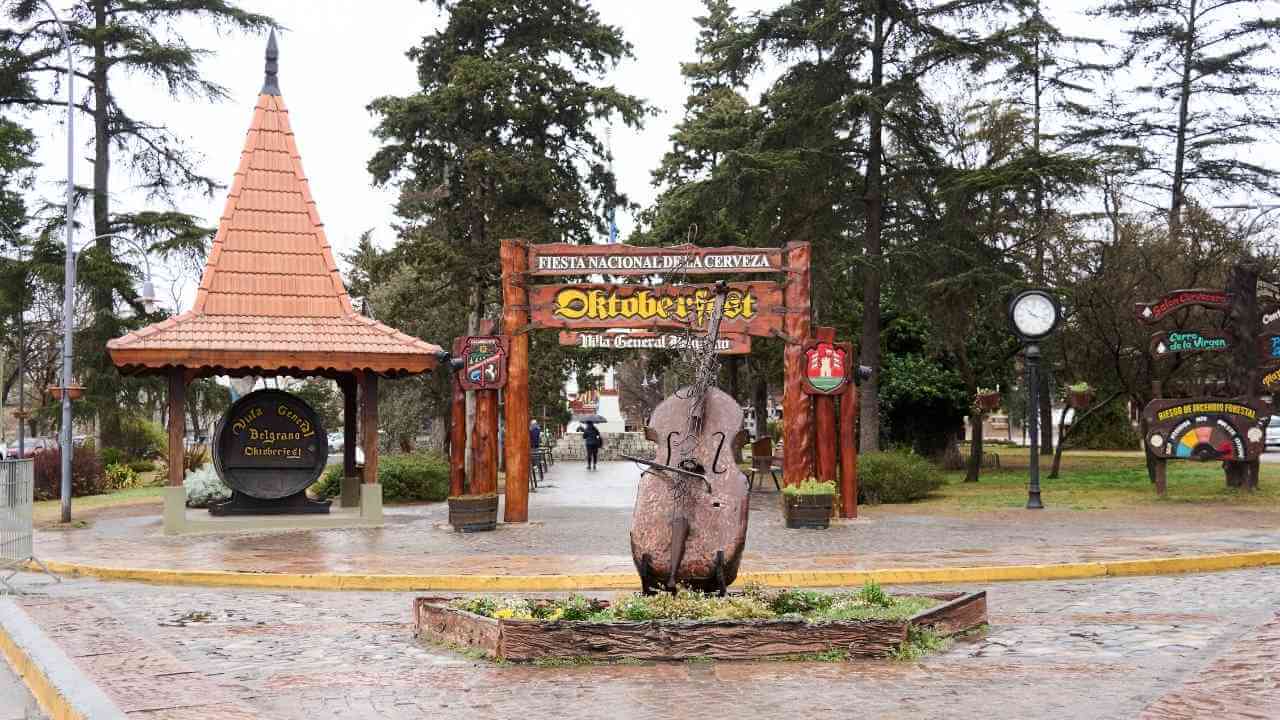 the entrance to a park with a statue in the middle